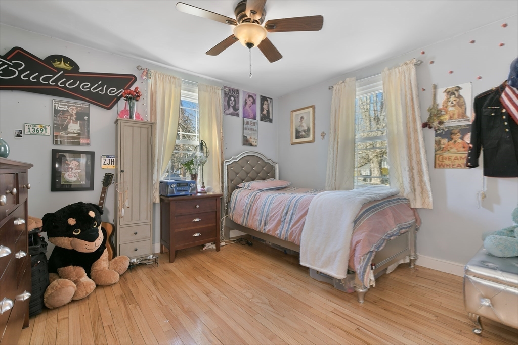 22 Stratford Road Natick, MA 01760 - Photo 23 of 41 a bedroom with a bed and wooden floor