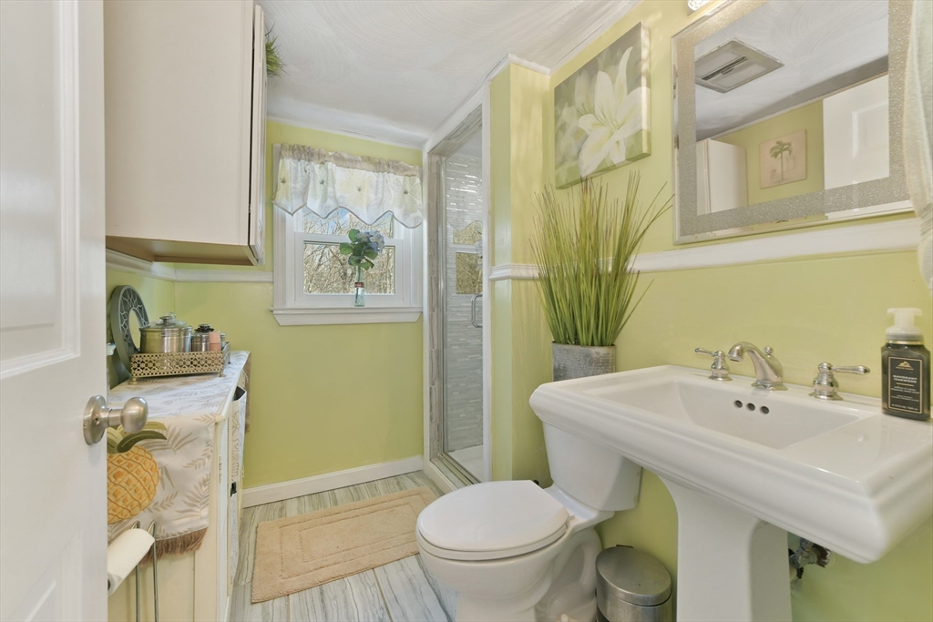 22 Stratford Road Natick, MA 01760 - Photo 27 of 41 a bathroom with a sink and mirror with toilet