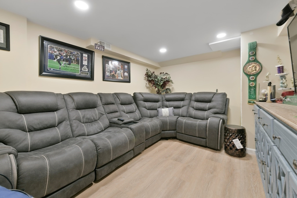 22 Stratford Road Natick, MA 01760 - Photo 28 of 41 a living room with furniture a wall painting and a lamp