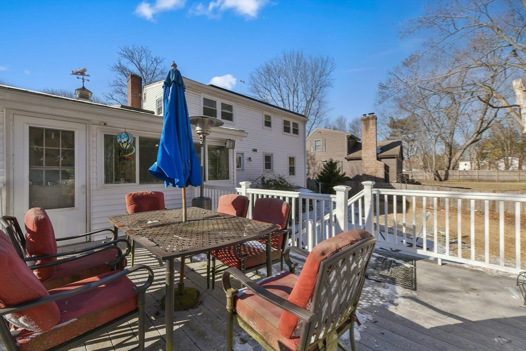 22 Stratford Road Natick, MA 01760 - Photo 31 of 41 a view of a patio with table and chairs with wooden floor and fence
