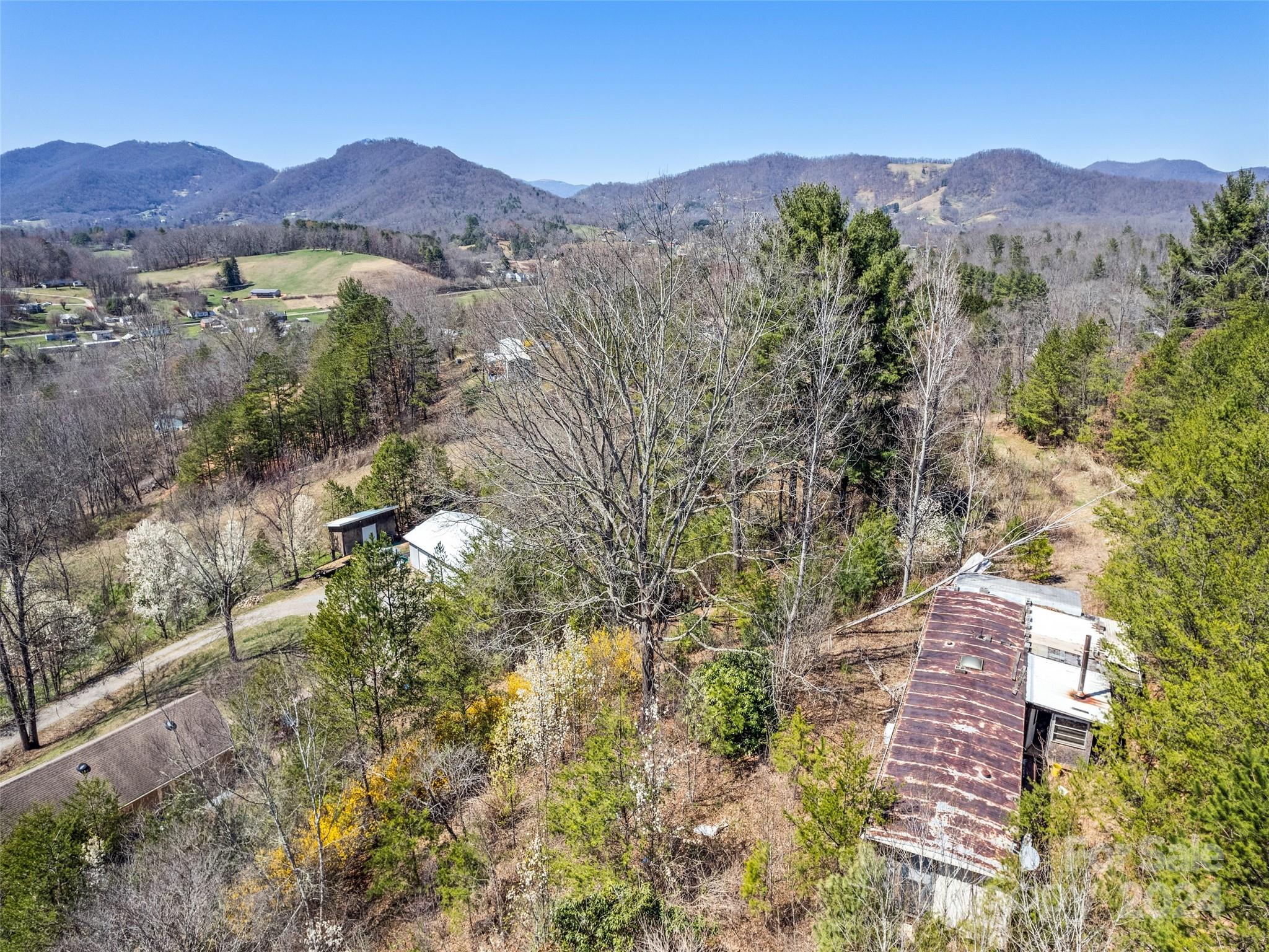 269 Turtle Springs Road, Unit LOT 10A Canton, NC 28716 - Photo 12 of 12 a view of a lush green hillside and houses