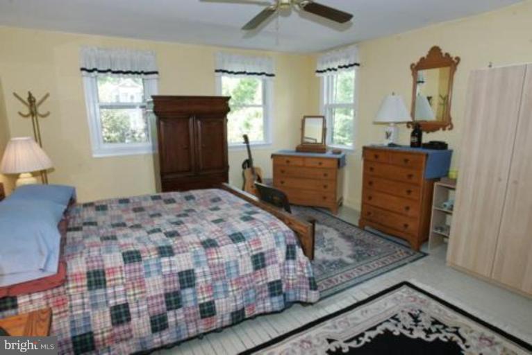 625 Deepdene Road Baltimore, MD 21210 - Photo 4 of 20 a bedroom with a bed and wooden floor