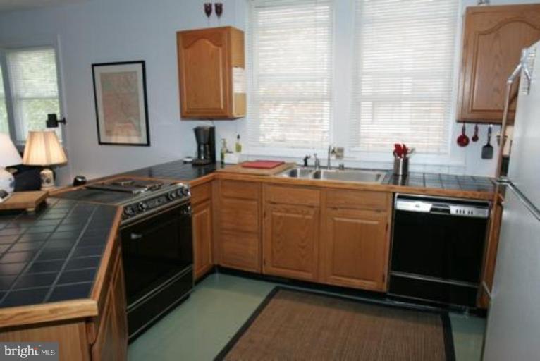 625 Deepdene Road Baltimore, MD 21210 - Photo 7 of 20 a kitchen with stainless steel appliances granite countertop a sink stove and microwave