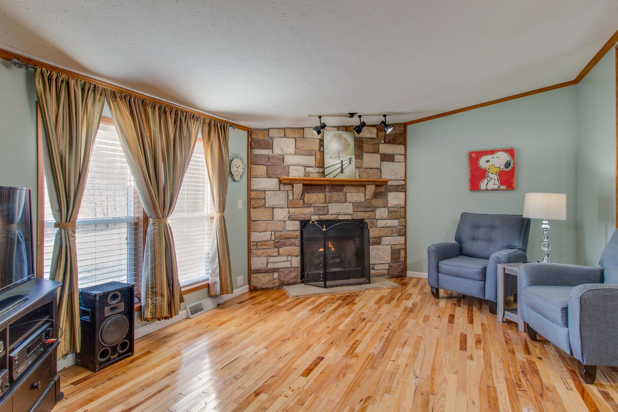 3957 Akin Ridge Road Williamsport, TN 38487 - Photo 7 of 28 Another view of the fireplace. The hickory hardwood floors are gorgeous!!
