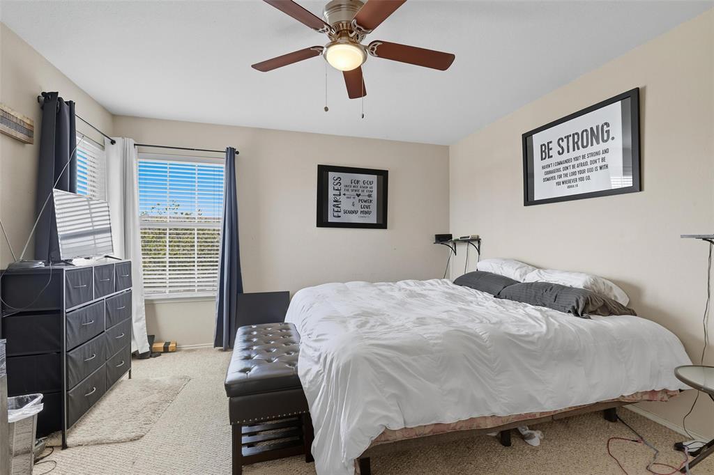 5200 Mountain Spring Trail Fort Worth, TX 76123 - Photo 15 of 23 a bedroom with a bed and a chandelier