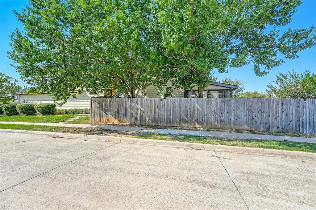 5200 Mountain Spring Trail Fort Worth, TX 76123 - Photo 18 of 23 a view of a backyard with wooden fence