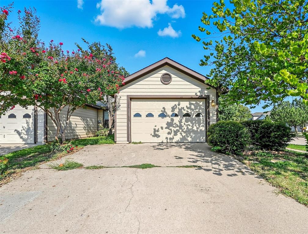 5200 Mountain Spring Trail Fort Worth, TX 76123 - Photo 2 of 23 a front view of a house with a yard and garage
