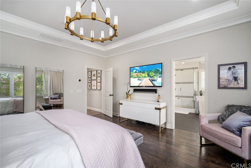 52 Umbria Irvine, CA 92618 - Photo 17 of 50 a bedroom with a bed and a chandelier