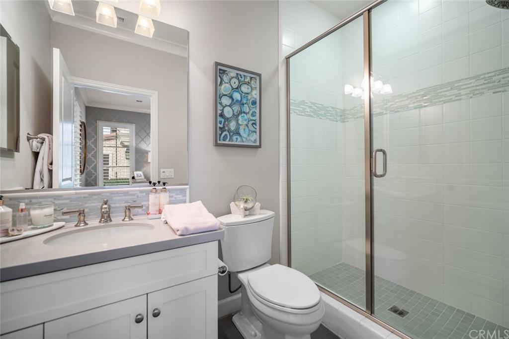 52 Umbria Irvine, CA 92618 - Photo 23 of 50 a bathroom with a sink a toilet a mirror and shower
