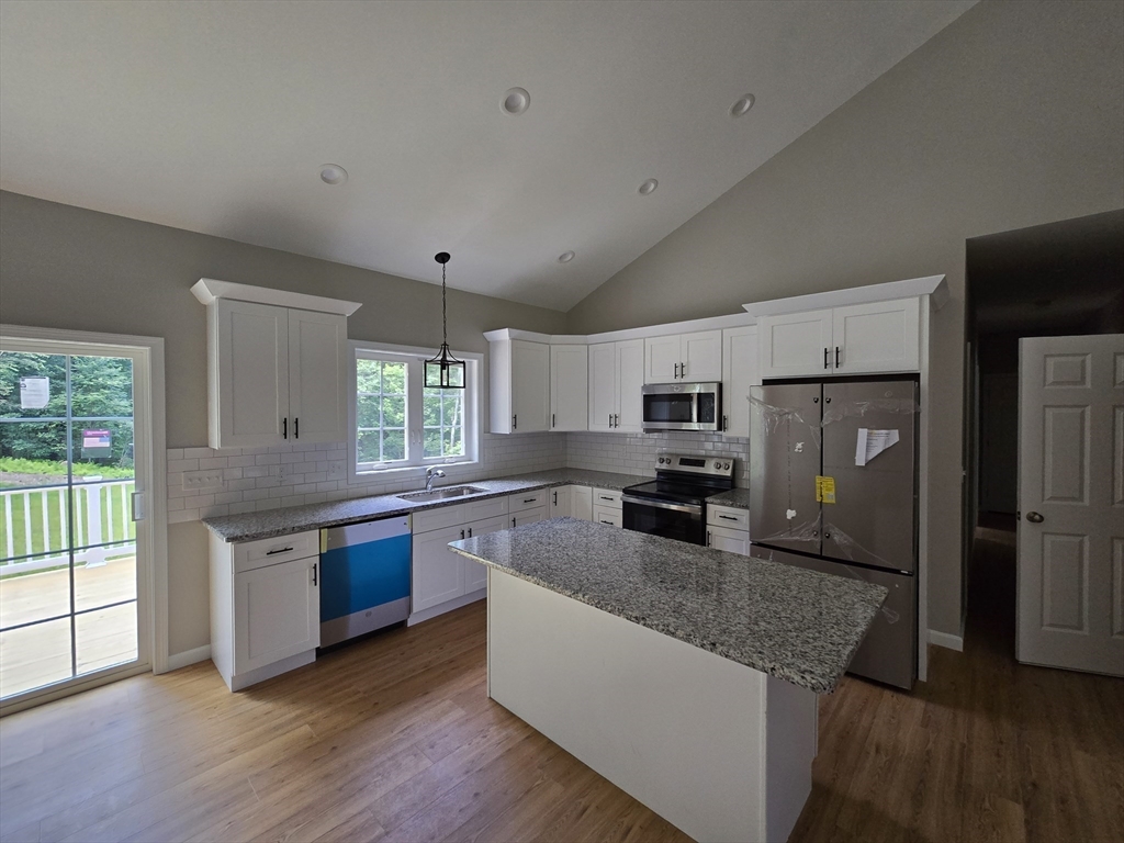 1242 Bemis Road Warren, MA 01083 - Photo 5 of 25 a kitchen with stainless steel appliances granite countertop a sink stove and refrigerator
