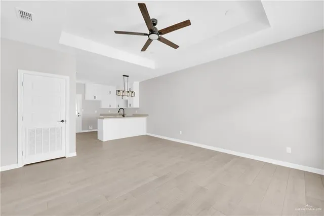 a view of a kitchen with a sink and cabinets