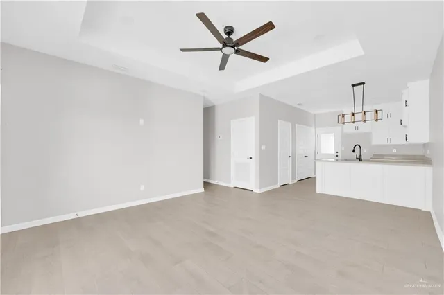 a kitchen with stainless steel appliances granite countertop white cabinets and refrigerator