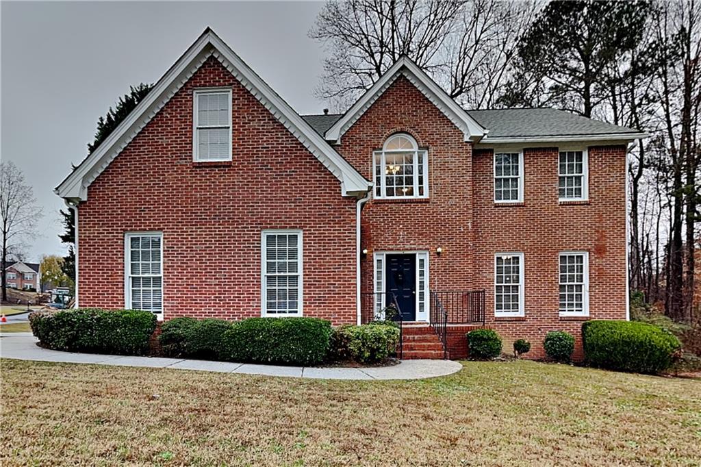 a front view of a house with a yard and garage