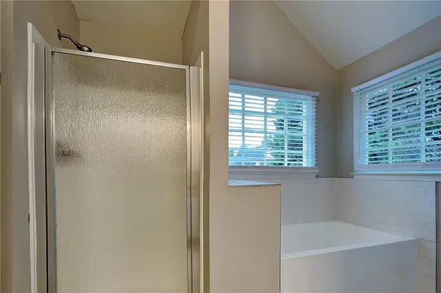 a bathroom with a shower and a bathtub