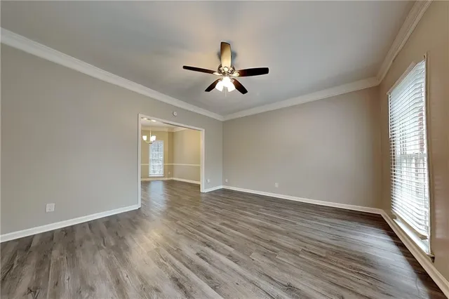 wooden floor in an empty room with a window