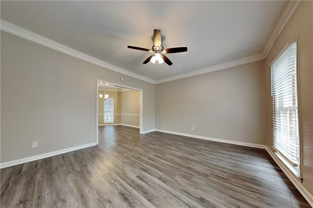 404 Rams Court Tucker, GA 30084 - Photo 3 of 21 wooden floor in an empty room with a window
