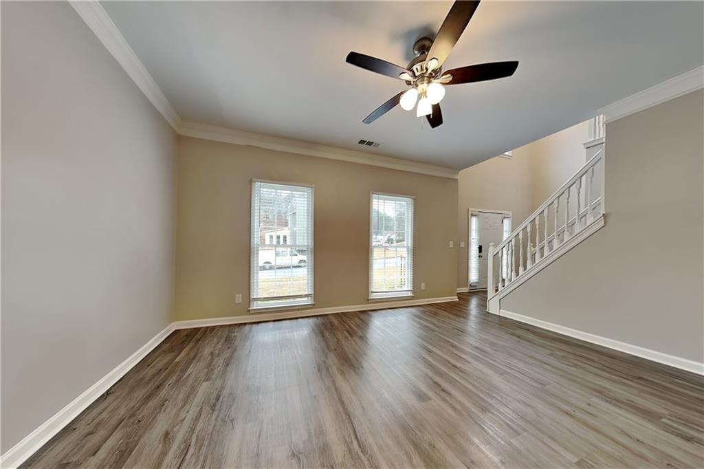 404 Rams Court Tucker, GA 30084 - Photo 4 of 21 a view of an empty room with wooden floor and a window