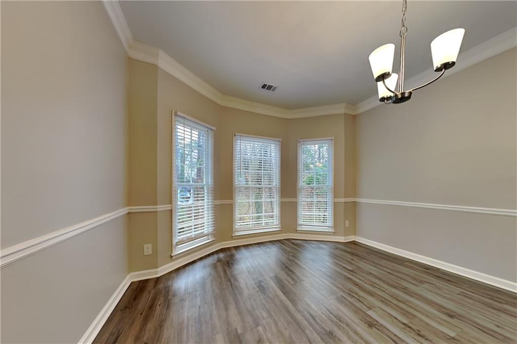404 Rams Court Tucker, GA 30084 - Photo 7 of 21 wooden floor in an empty room with a window