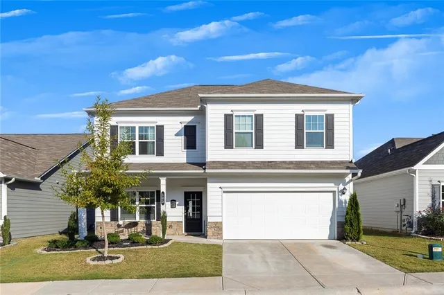 a front view of a house with a yard