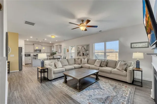 a living room with furniture or kitchen view and a wooden floor