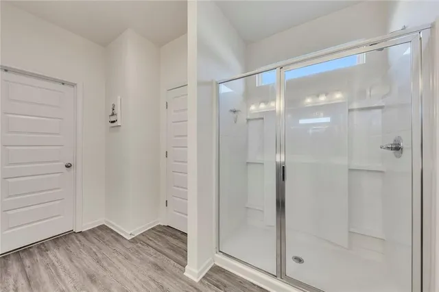a bathroom with a glass shower door