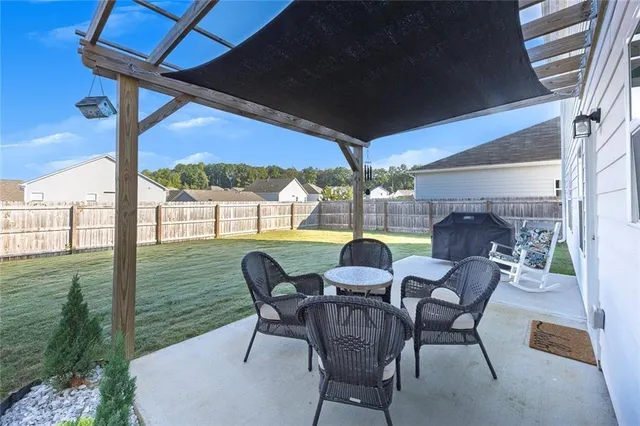 a view of a porch with furniture and a yard