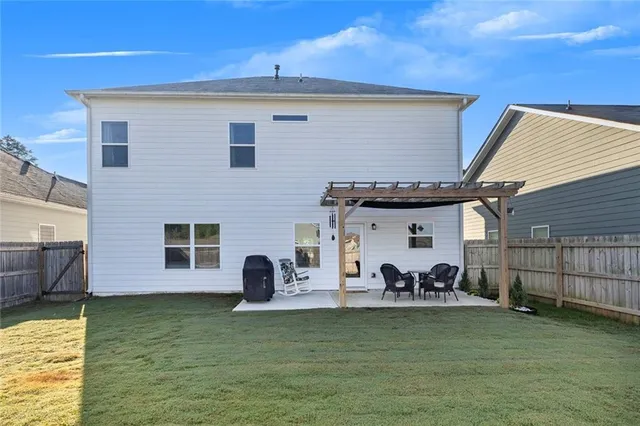a view of a patio with table and chairs