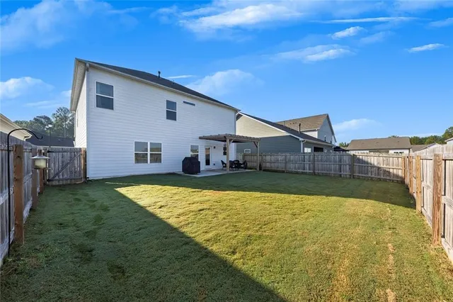 a view of a house with pool and yard