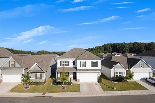 an aerial view of a house with a yard