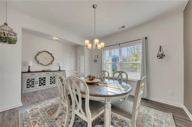a view of a dining room and chandelier fan