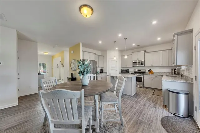 a view of a dining room with furniture and wooden floor