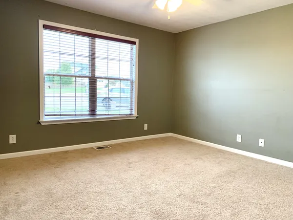 an empty room with a empty space and windows