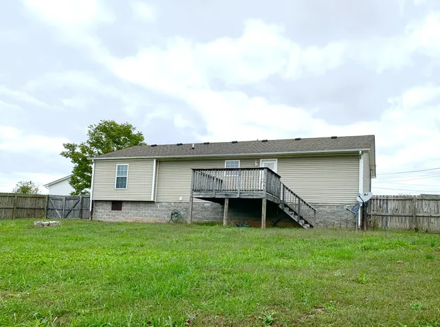 a backyard of a house with table and chairs