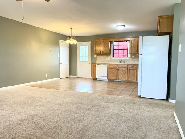 a view of a kitchen with a sink and a refrigerator