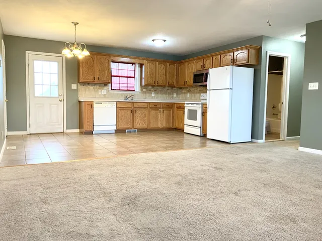 a view of a kitchen with refrigerator and a dishwasher