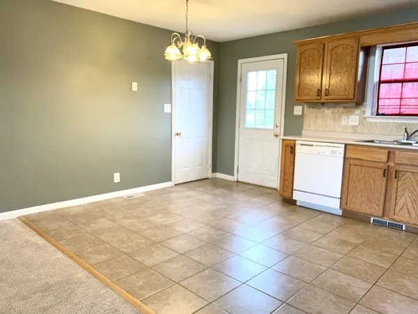 a view of a kitchen with a sink and dishwasher cabinets