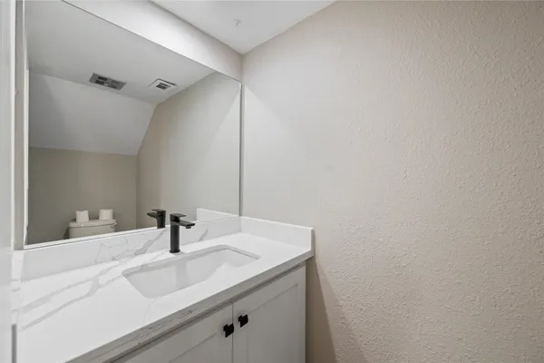 a bathroom with a sink and vanity