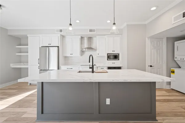 a large kitchen with kitchen island a sink stainless steel appliances and cabinets