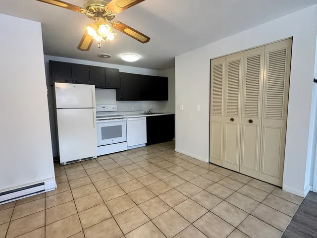 a view of a kitchen with a microwave and a refrigerator