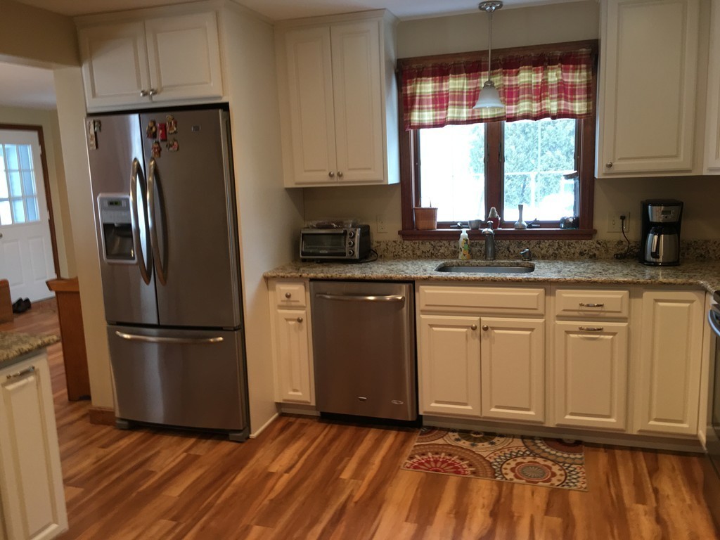 48 Kimball Road Amesbury, MA 01913 - Photo 5 of 30 a kitchen with granite countertop a refrigerator sink and cabinets