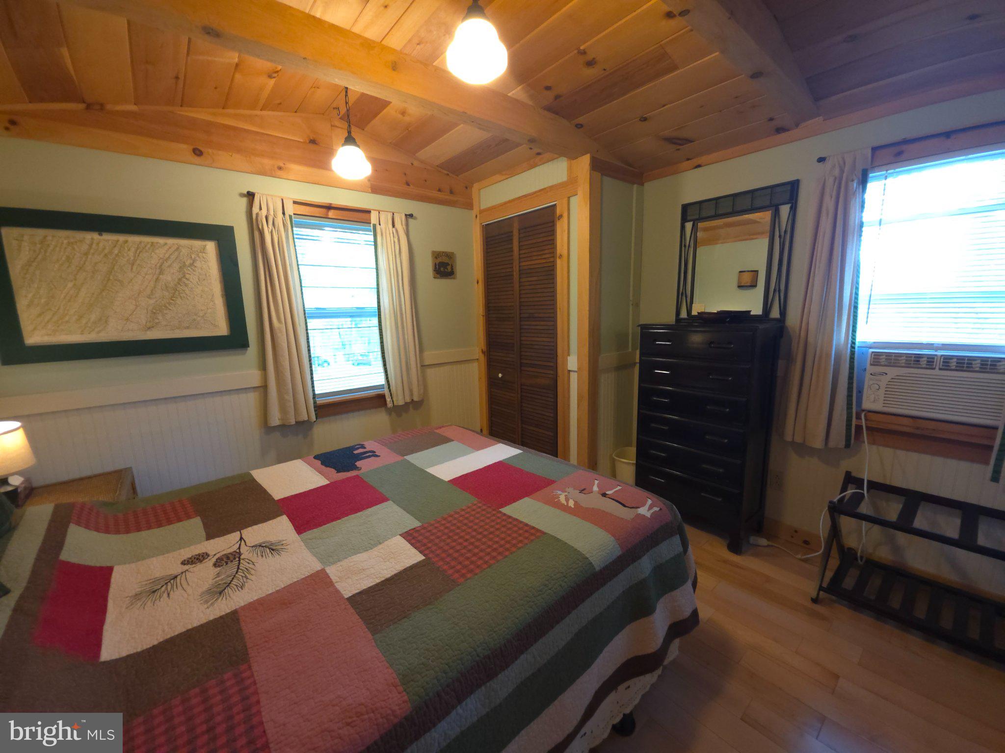 152 Sharp Ridge Lane Franklin, WV 26807 - Photo 24 of 53 a bedroom with a bed and wooden floor