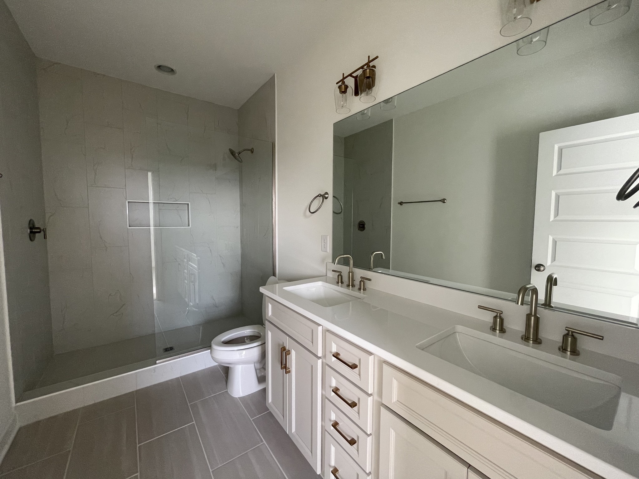 153 Bess Boulevard Spring Hill, TN 37174 - Photo 16 of 22 a bathroom with a sink a toilet a shower and a mirror