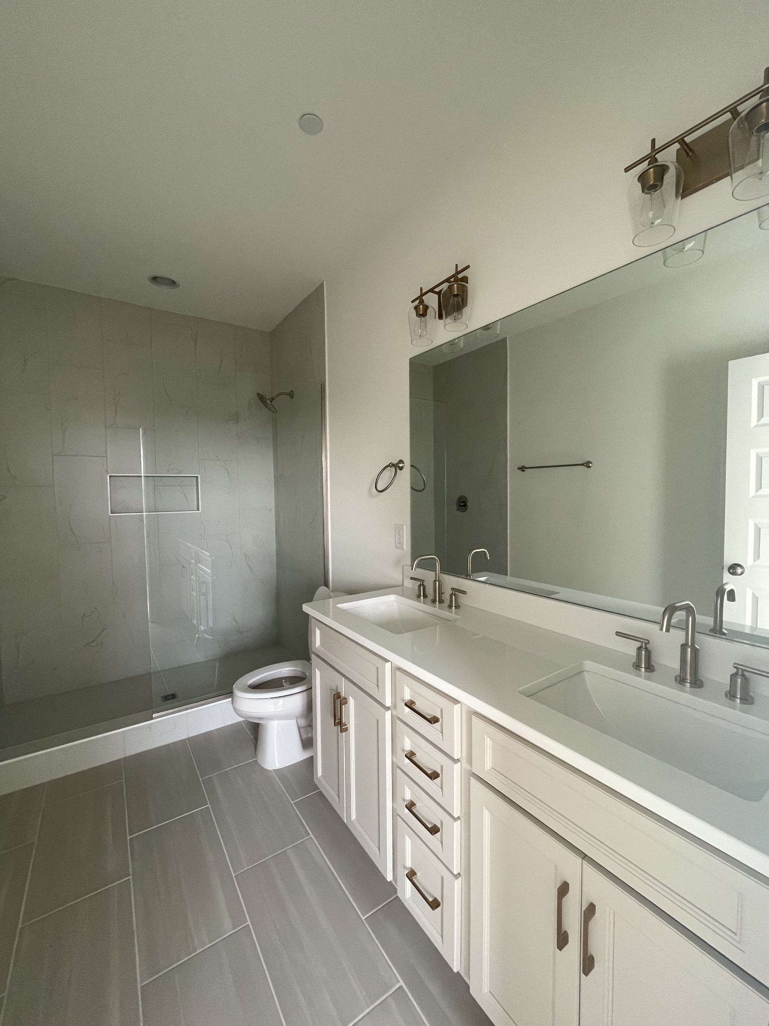 153 Bess Boulevard Spring Hill, TN 37174 - Photo 17 of 22 a spacious bathroom with a granite countertop sink a toilet and a mirror