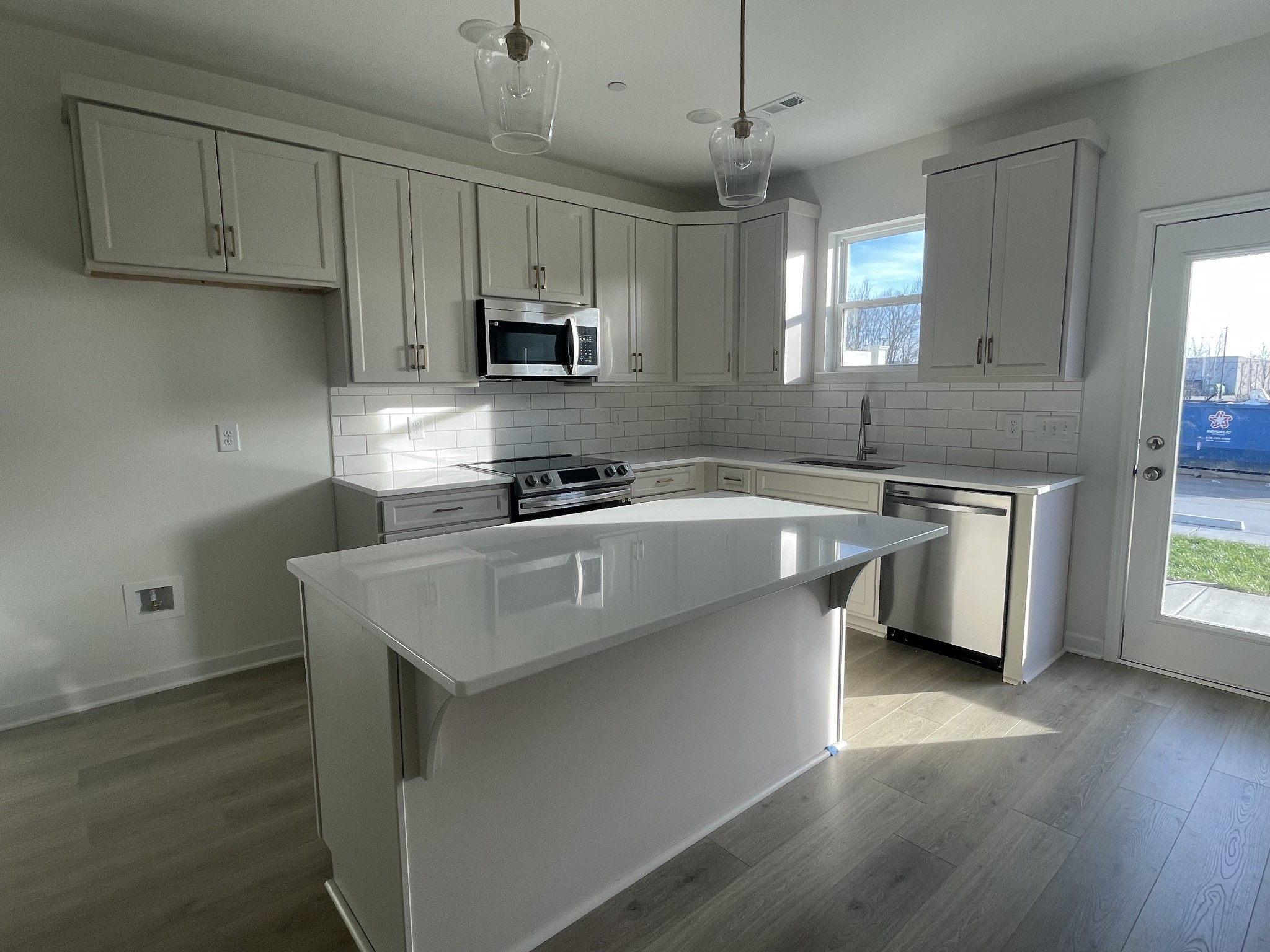 153 Bess Boulevard Spring Hill, TN 37174 - Photo 2 of 22 a kitchen with stainless steel appliances a sink a stove a microwave a center island and cabinets