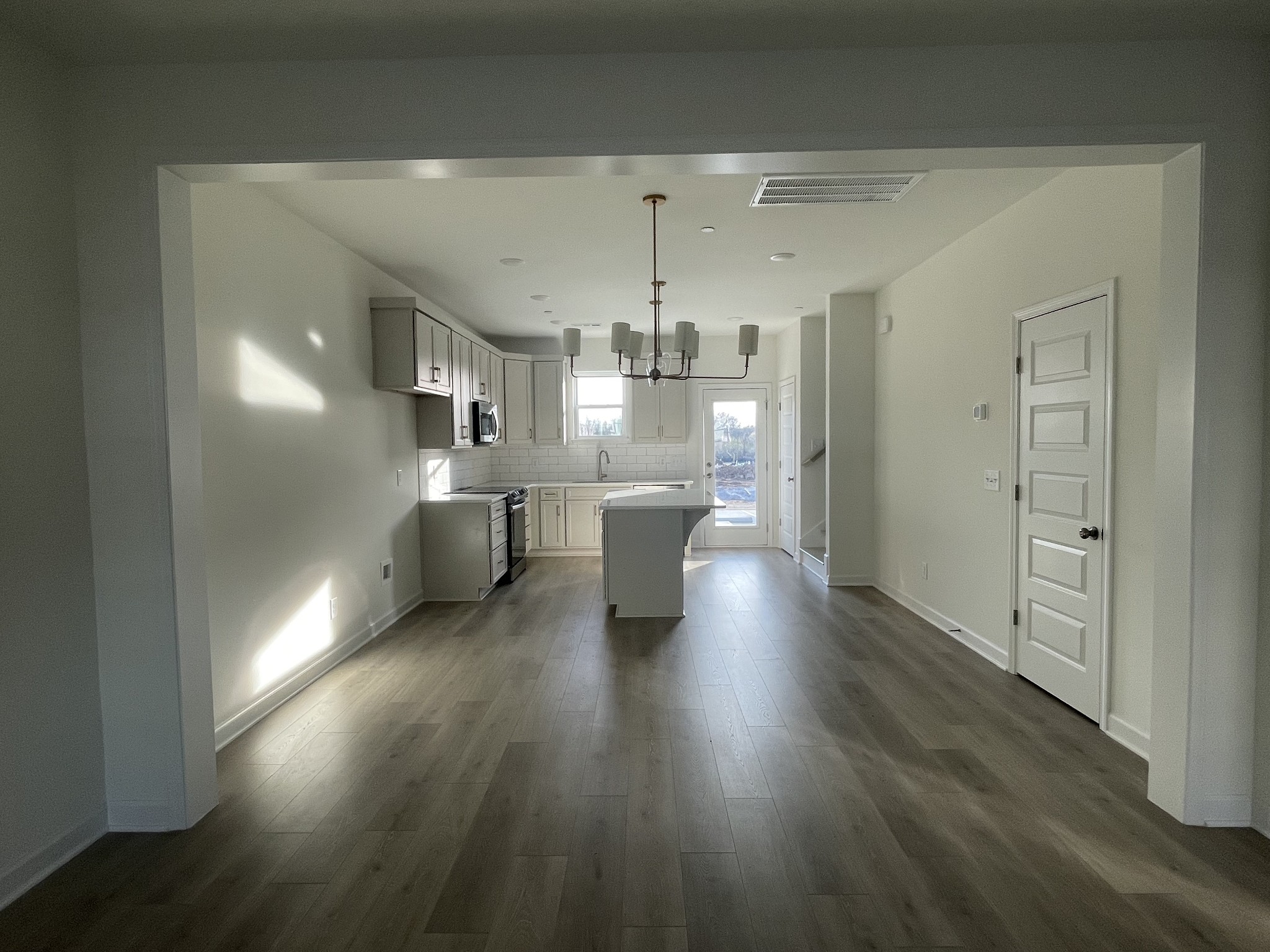 153 Bess Boulevard Spring Hill, TN 37174 - Photo 5 of 22 a view of a living room and kitchen with a hardwood floor