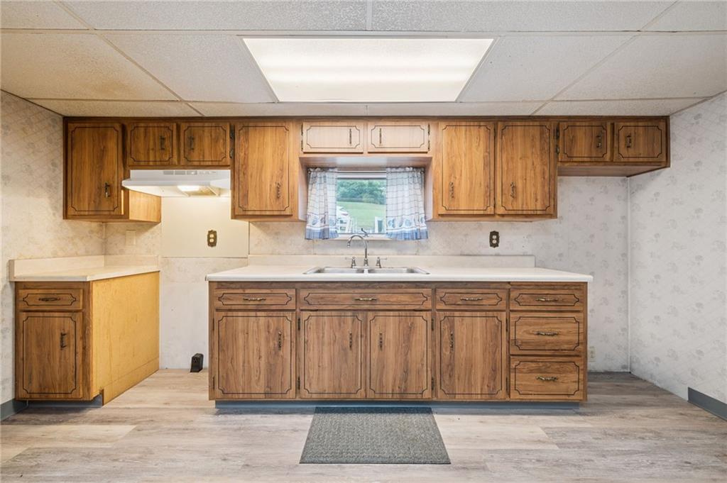 178 Locust Street Muse, PA 15350 - Photo 17 of 28 a kitchen with stainless steel appliances granite countertop a sink and cabinets