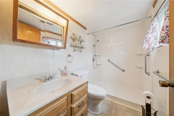 a bathroom with a sink a toilet and shower