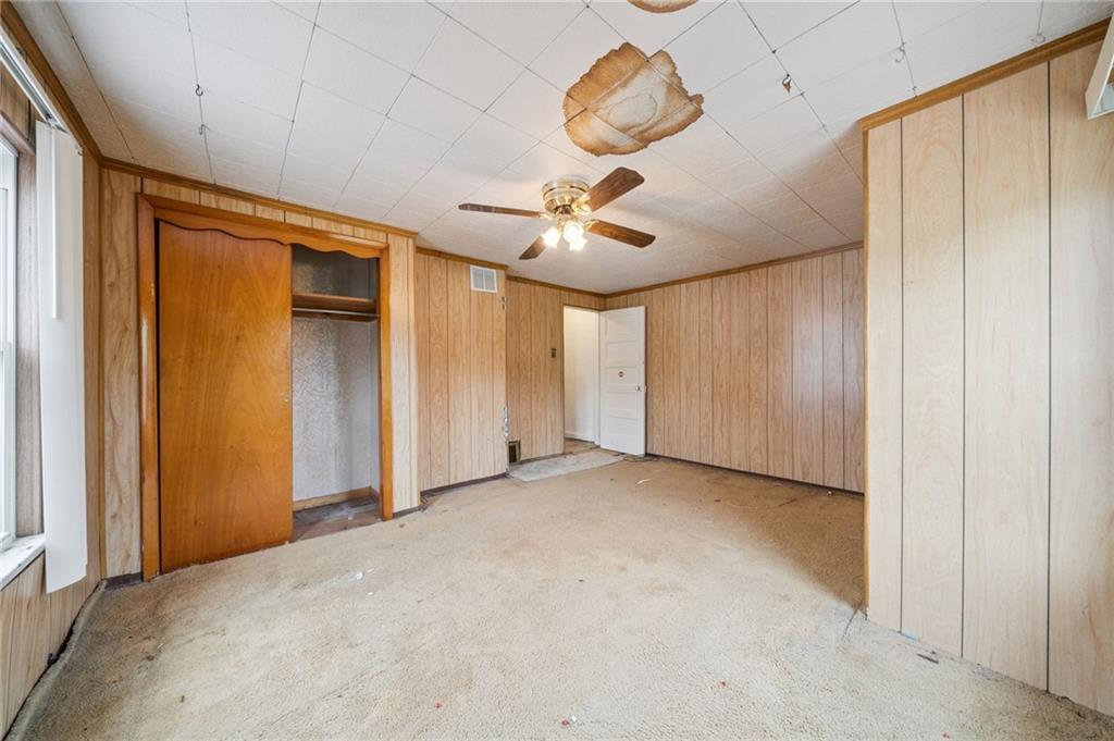 178 Locust Street Muse, PA 15350 - Photo 25 of 28 an empty room with a ceiling fan and carpet