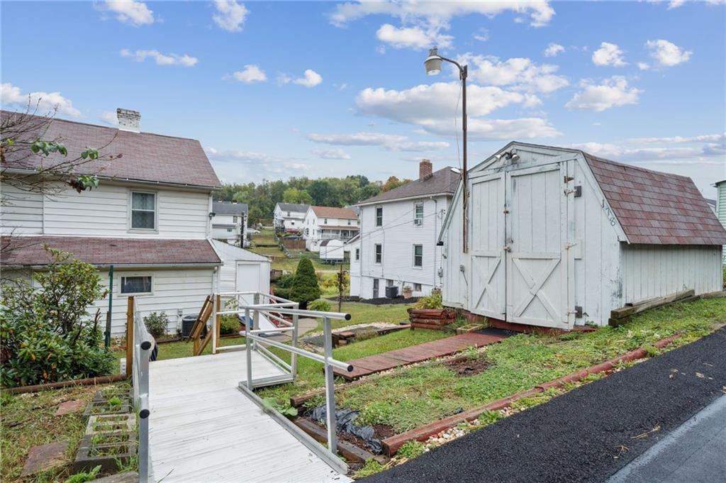 178 Locust Street Muse, PA 15350 - Photo 7 of 28 a front view of a house with a garden and plants