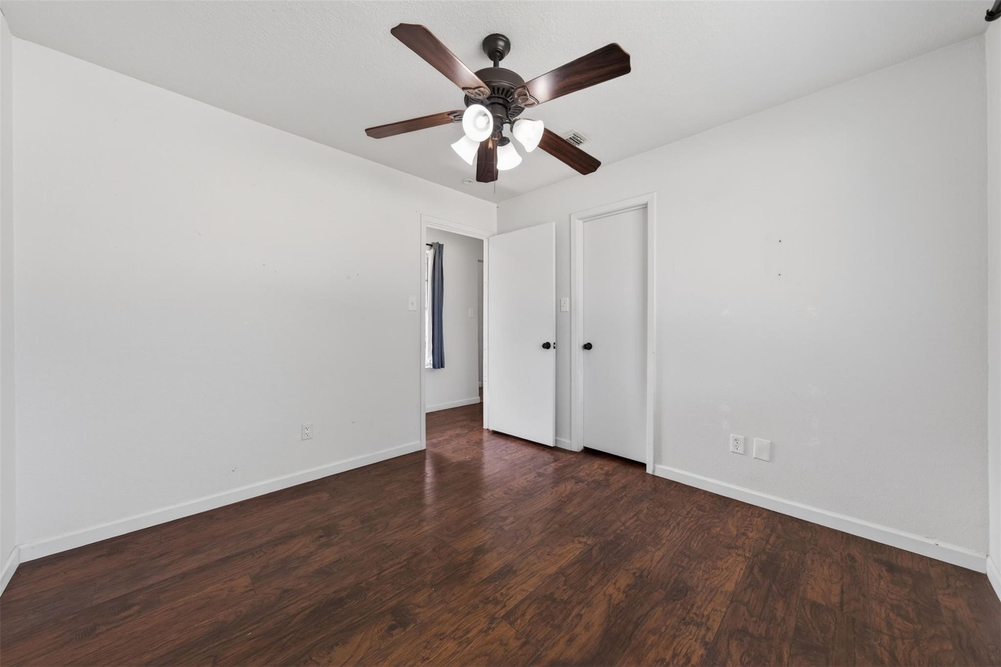 17002 Dew Drop Lane Houston, TX 77095 - Photo 14 of 24 an empty room with wooden floor and ceiling fan